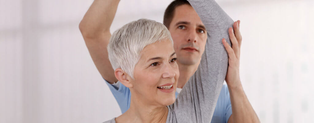 Old woman doing physical therapy for pain relief